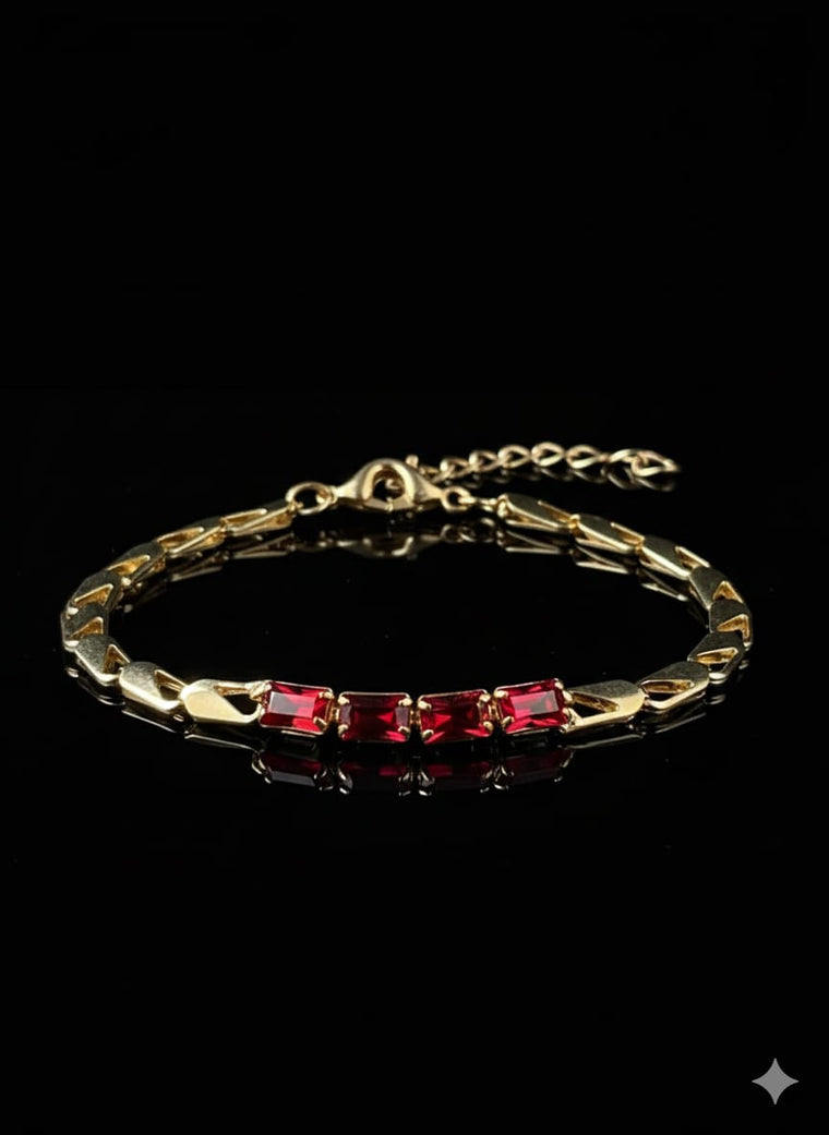 A gold Bracelet Adorned With Red Stones