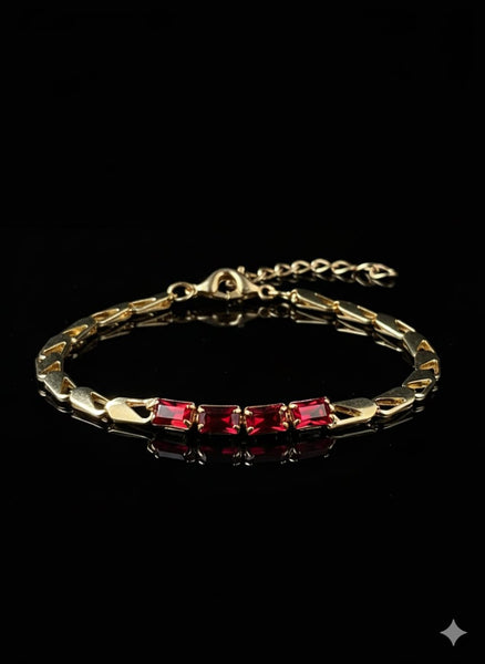 A gold Bracelet Adorned With Red Stones