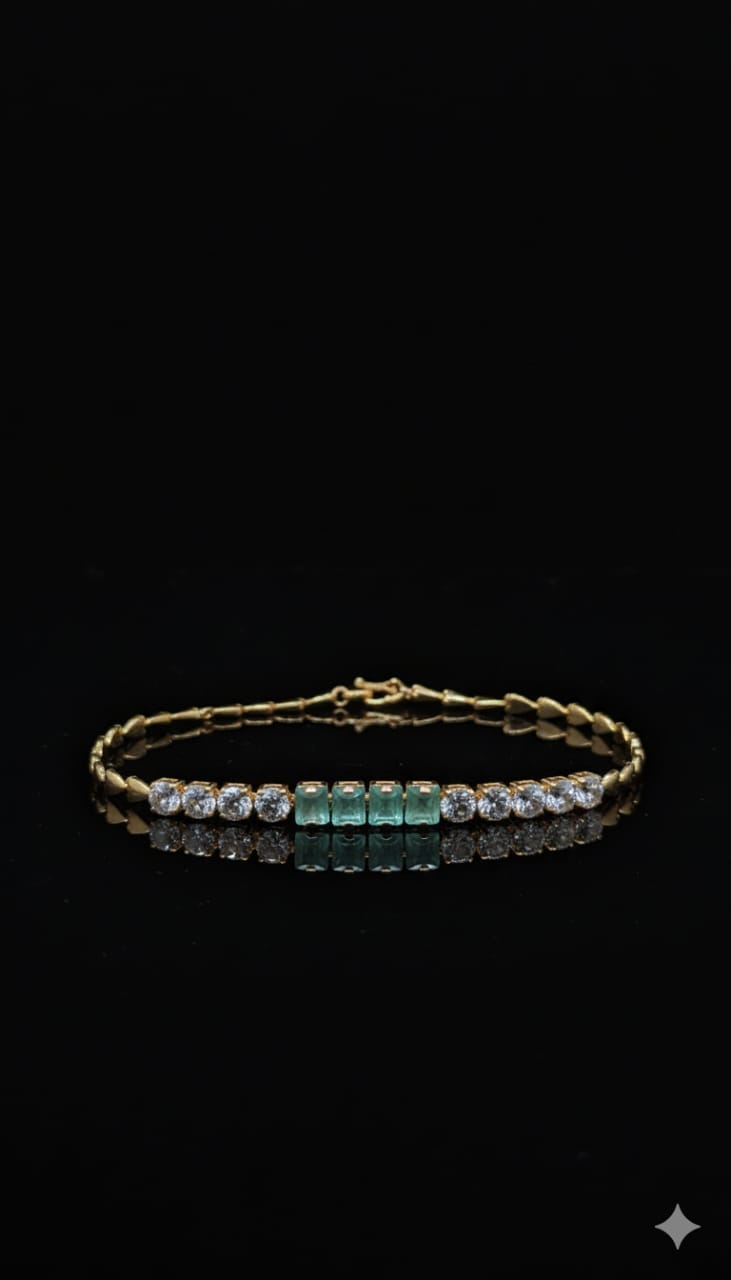 Gold Bracelet Adorned With Emerald Stones